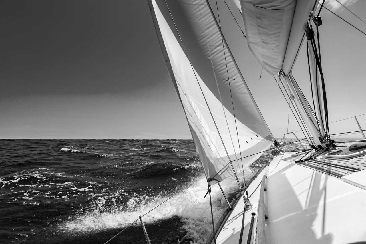 Sailing lboat at open sea in sunshine White sailing boat at open sea in sunshine