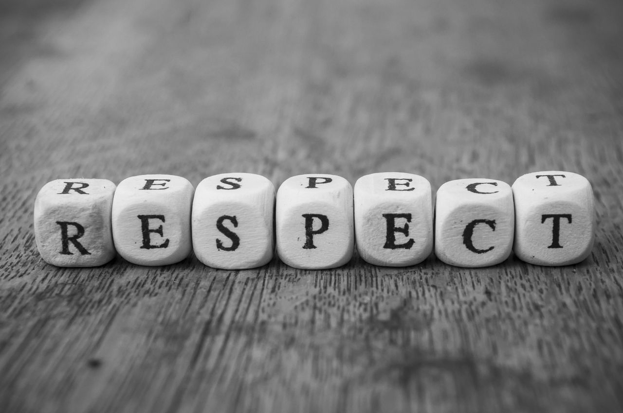 Closeup of word on wooden cube on wooden desk background concept - Respect Closeup of word on wooden cube on wooden desk background concept - Respect